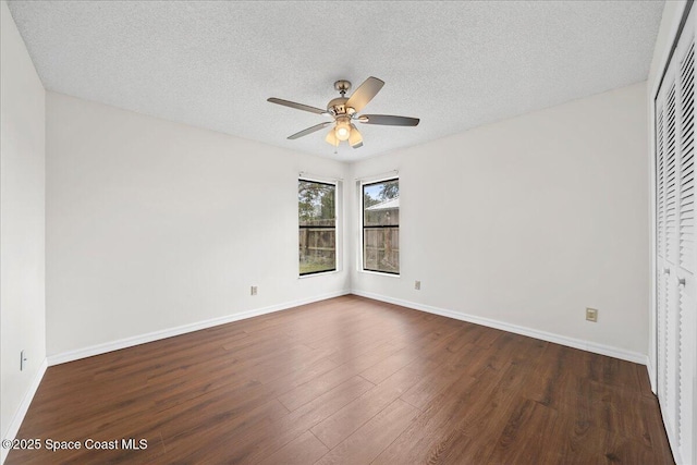 interior space featuring ceiling fan, dark hardwood / wood-style floors, a textured ceiling, and a closet