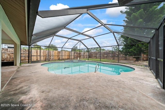 view of pool with an in ground hot tub, a patio, and glass enclosure