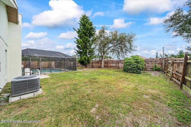 view of yard with a fenced in pool, cooling unit, and a lanai