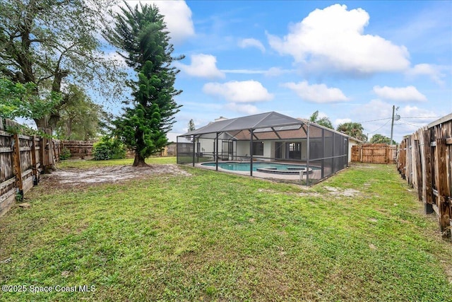 view of yard with glass enclosure and a fenced in pool