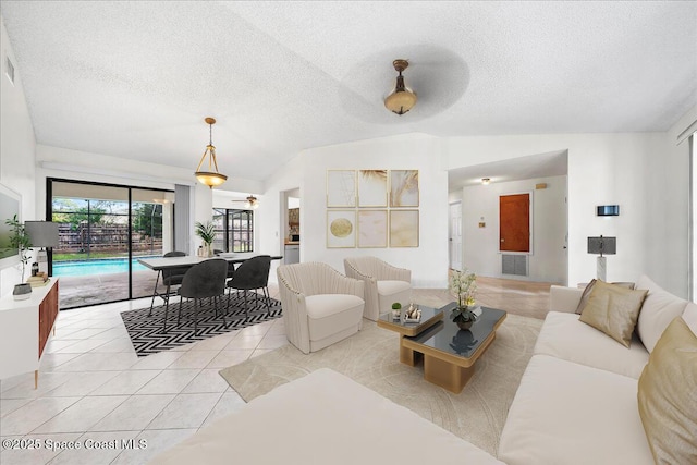 tiled living room with lofted ceiling and a textured ceiling