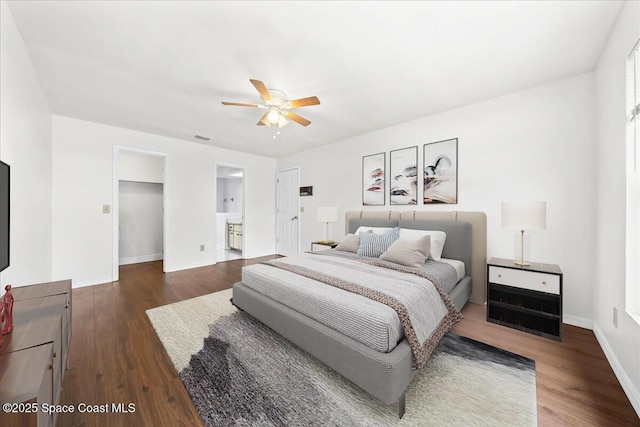 bedroom featuring connected bathroom, dark hardwood / wood-style floors, and ceiling fan