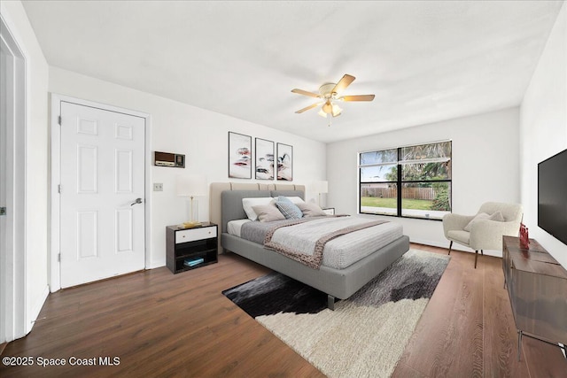 bedroom with ceiling fan and dark hardwood / wood-style flooring