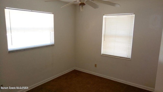 spare room featuring baseboards and a ceiling fan