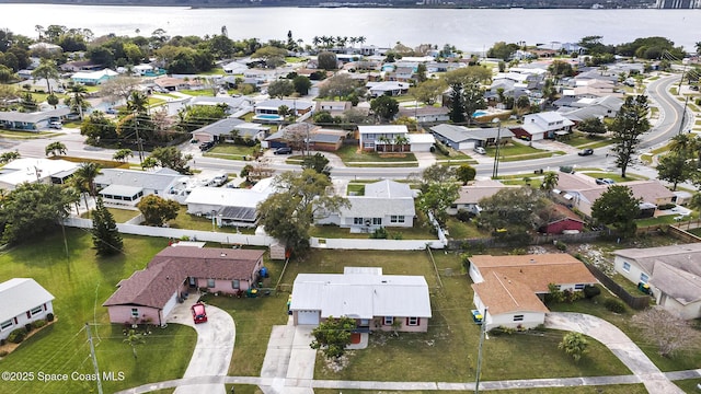 drone / aerial view featuring a residential view and a water view