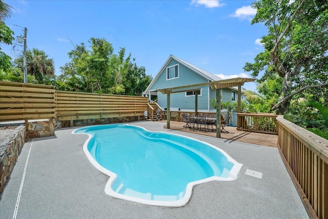 view of swimming pool with a deck