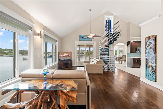 living room with vaulted ceiling, a water view, ceiling fan, and hardwood / wood-style floors