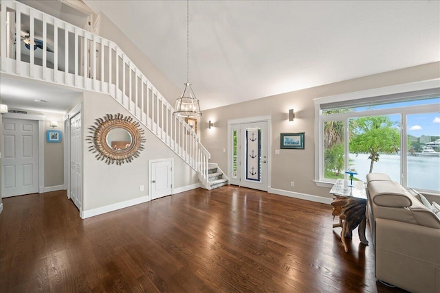 living room featuring a water view and dark hardwood / wood-style flooring