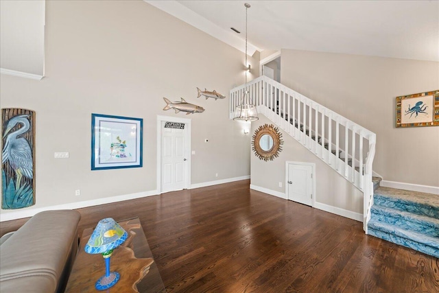 unfurnished living room featuring hardwood / wood-style floors and a towering ceiling