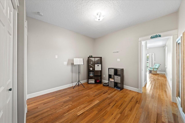 interior space featuring hardwood / wood-style floors and a textured ceiling