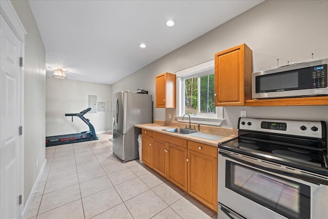 kitchen with sink, light tile patterned floors, and appliances with stainless steel finishes