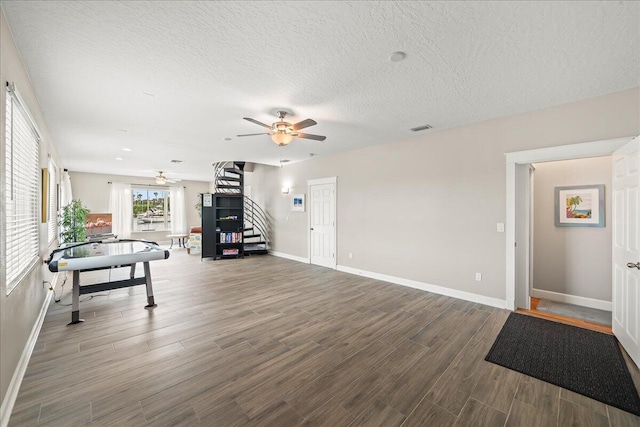 rec room with hardwood / wood-style floors, a textured ceiling, and ceiling fan