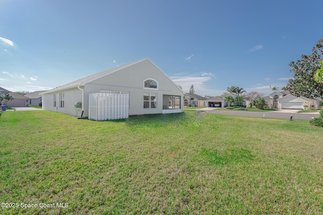 back of property with a lawn