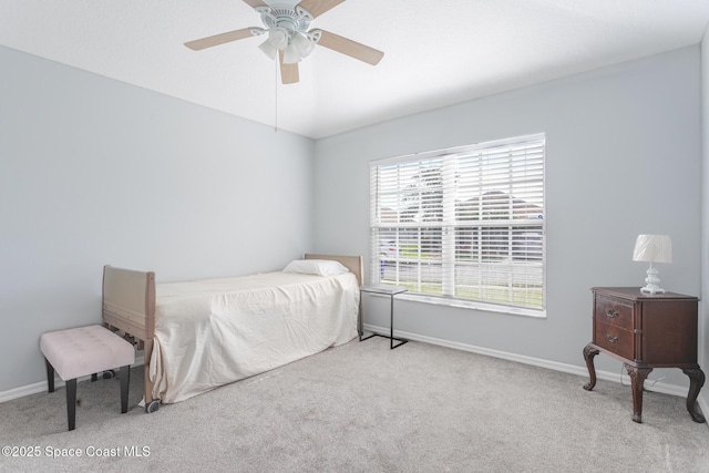 bedroom featuring light colored carpet and ceiling fan