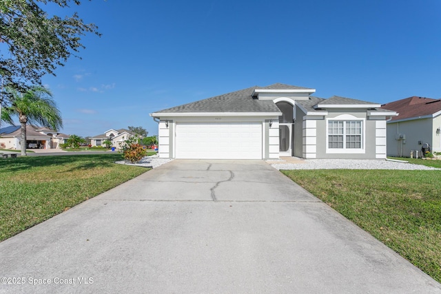 view of front facade with a front yard and a garage