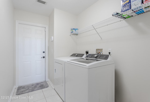 washroom with light tile patterned flooring and independent washer and dryer