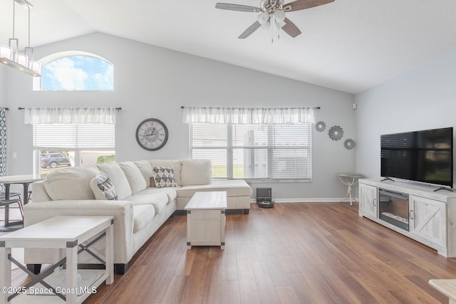 living room featuring a wealth of natural light, hardwood / wood-style floors, and ceiling fan