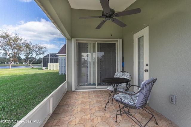 view of patio / terrace featuring ceiling fan and a lanai