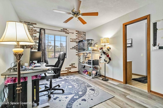 home office with ceiling fan and hardwood / wood-style flooring