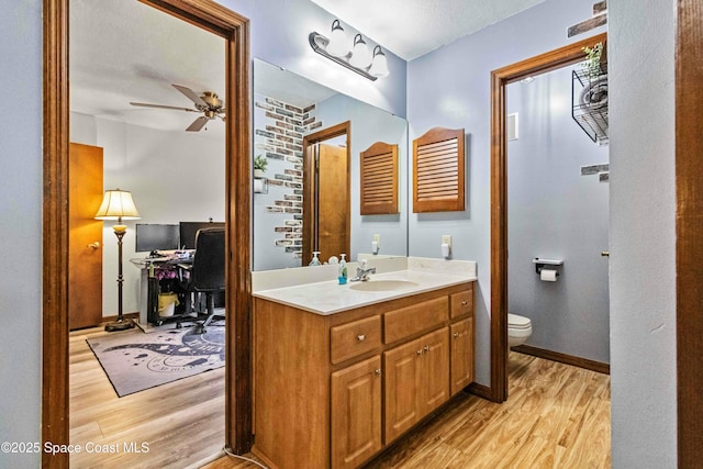 bathroom featuring vanity, ceiling fan, toilet, a textured ceiling, and wood-type flooring