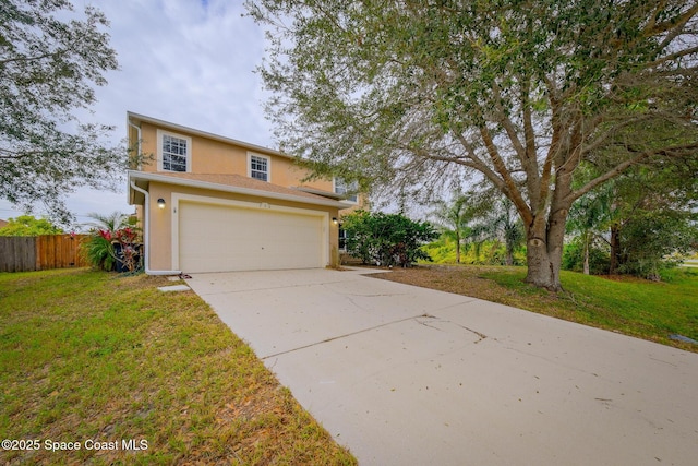 view of property with a garage and a front lawn