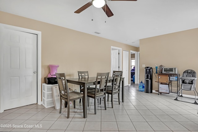 dining area featuring ceiling fan and light tile patterned flooring