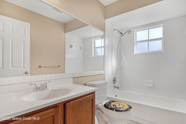 full bathroom with vanity, toilet, and tiled shower / bath