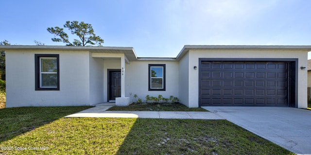 single story home with a front yard and a garage