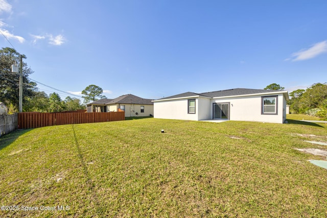 rear view of property with a yard