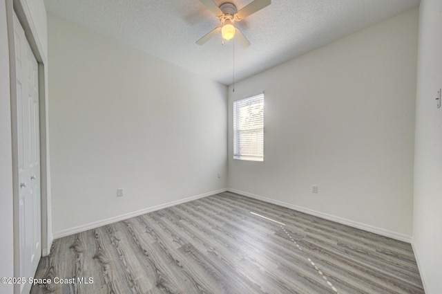 unfurnished bedroom with a textured ceiling, a closet, ceiling fan, and light hardwood / wood-style floors