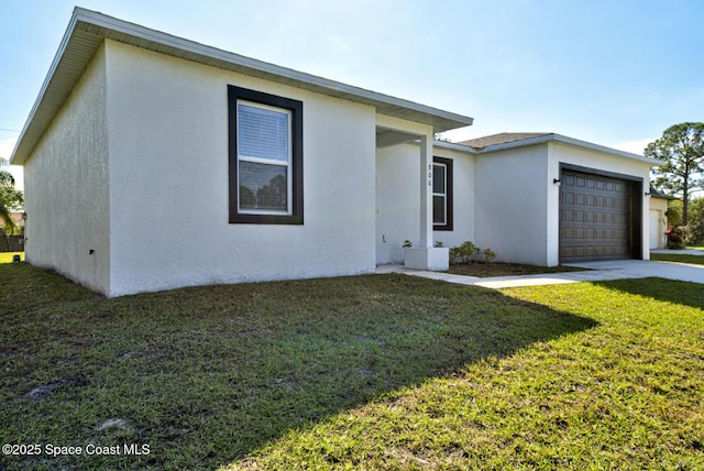 view of front of home with a front lawn and a garage