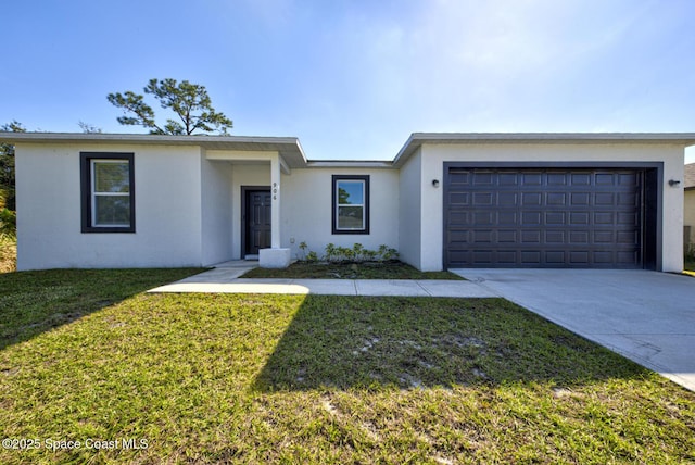 ranch-style house featuring a front lawn and a garage