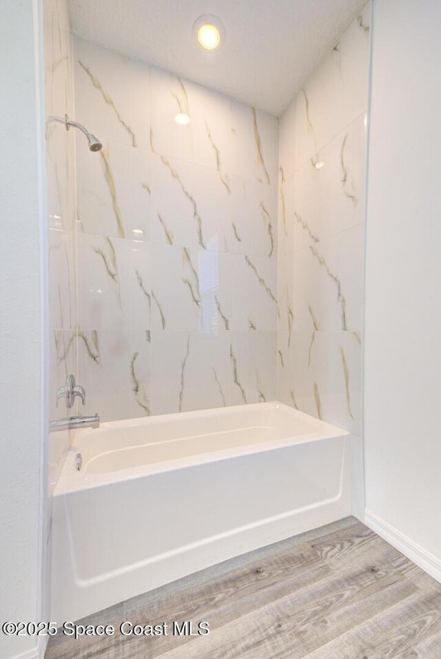 bathroom featuring hardwood / wood-style floors and shower / bathing tub combination