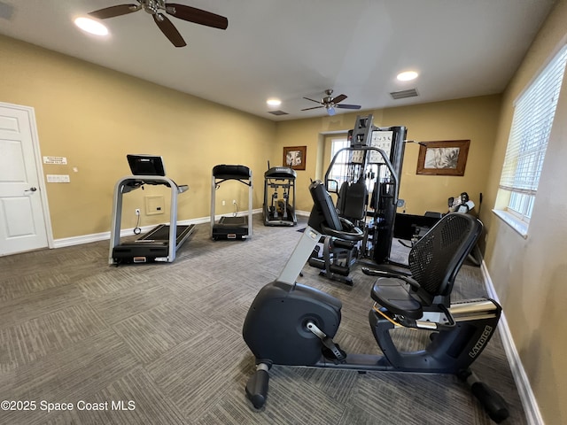 exercise room featuring ceiling fan, carpet, and a healthy amount of sunlight