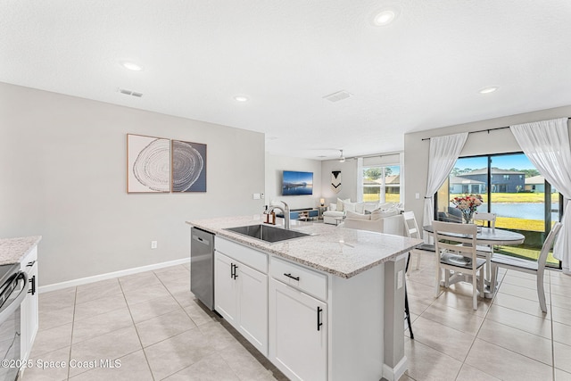 kitchen featuring dishwasher, a center island with sink, sink, light stone counters, and white cabinetry