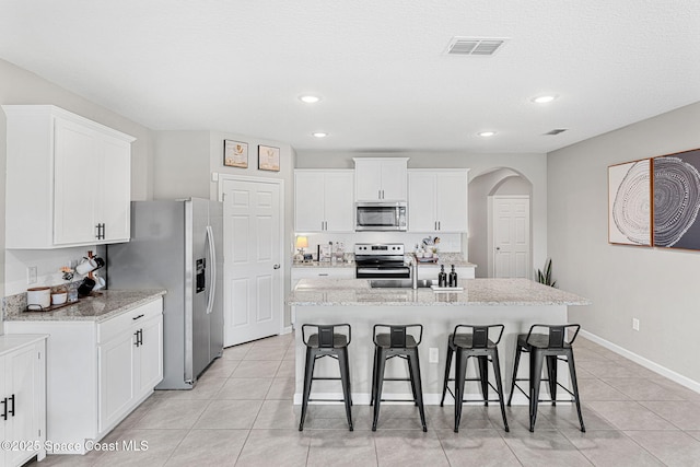 kitchen featuring white cabinetry, a kitchen island with sink, and appliances with stainless steel finishes