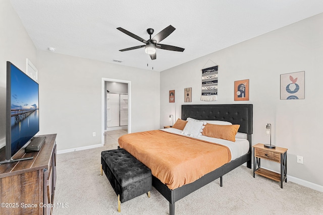 carpeted bedroom featuring ensuite bath and ceiling fan