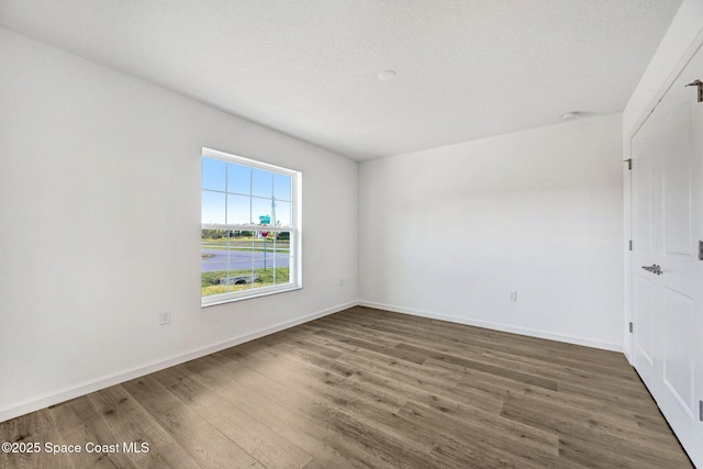 unfurnished room featuring dark hardwood / wood-style floors