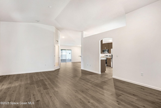 unfurnished living room with dark wood-type flooring and lofted ceiling