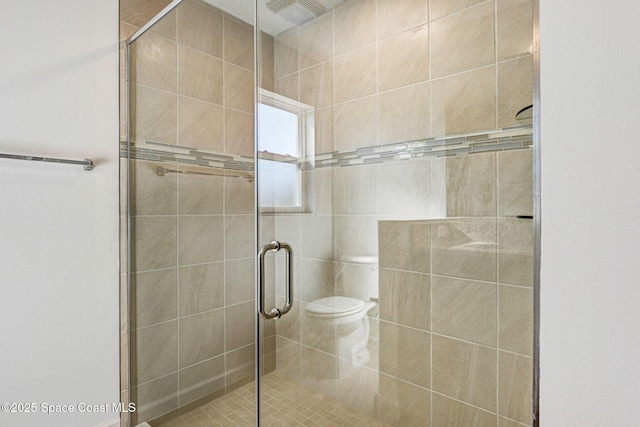 bathroom with toilet and walk in shower