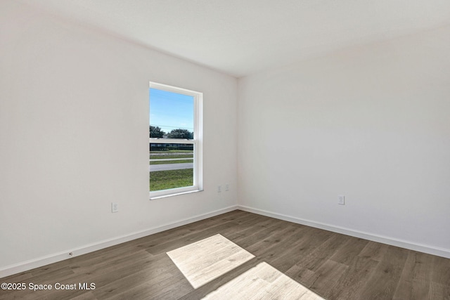 spare room featuring dark hardwood / wood-style flooring