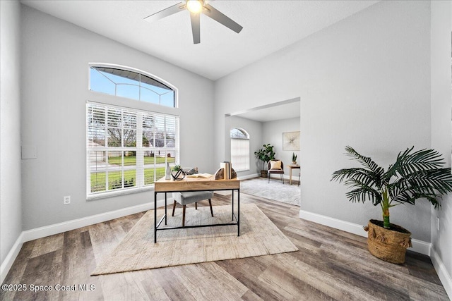 home office featuring hardwood / wood-style flooring and ceiling fan