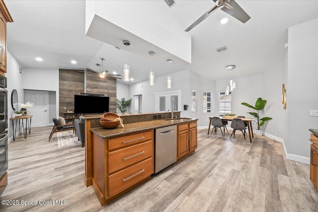 kitchen featuring dishwasher, dark stone counters, hanging light fixtures, ceiling fan, and a textured ceiling