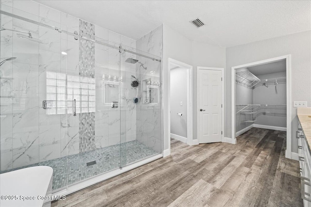 bathroom featuring a shower with shower door, wood-type flooring, and vanity