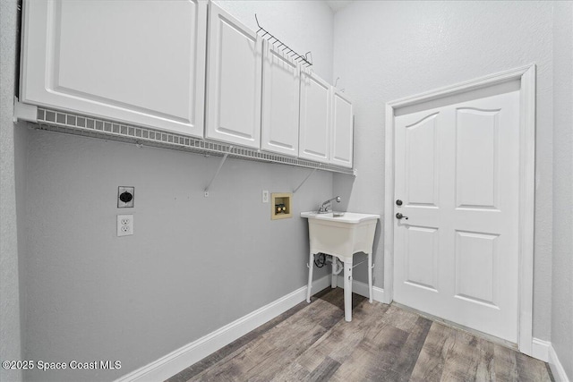 laundry room featuring cabinets, hookup for a washing machine, hardwood / wood-style flooring, and electric dryer hookup