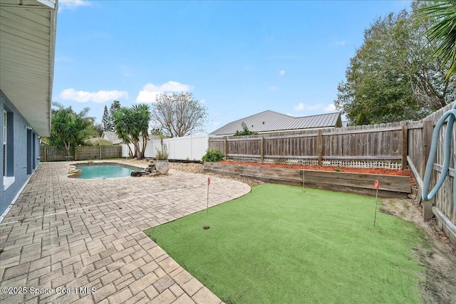 view of yard featuring a fenced in pool and a patio