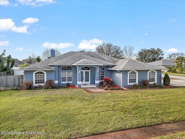 ranch-style house featuring french doors and a front lawn