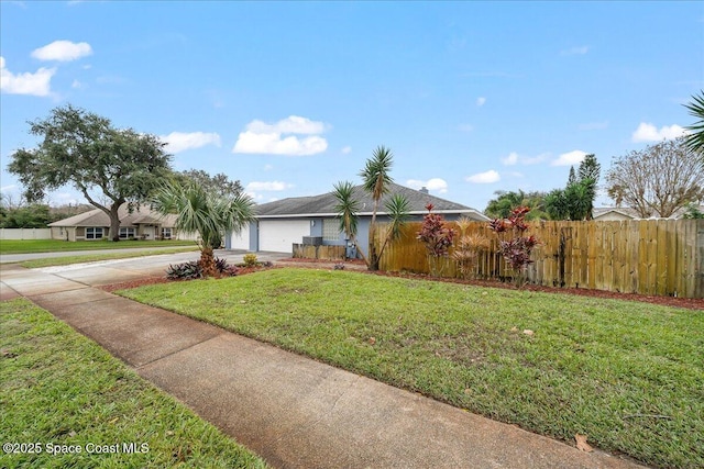 view of front facade featuring a front lawn and a garage