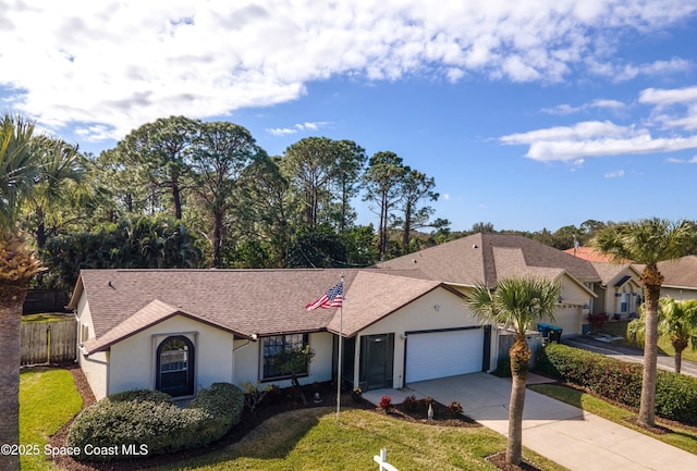 ranch-style home with a garage and a front lawn