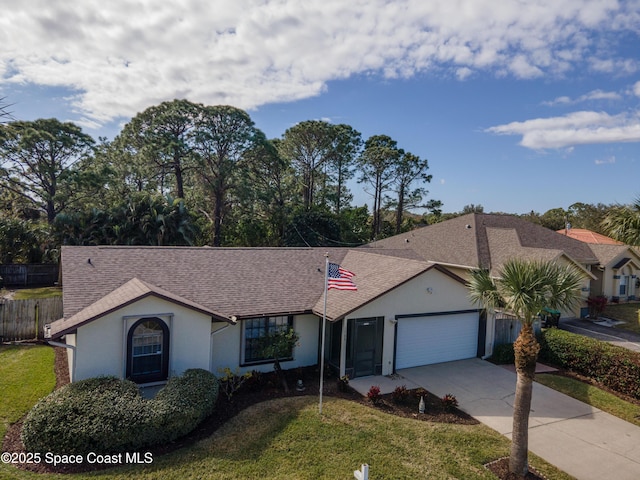 single story home featuring a garage and a front yard